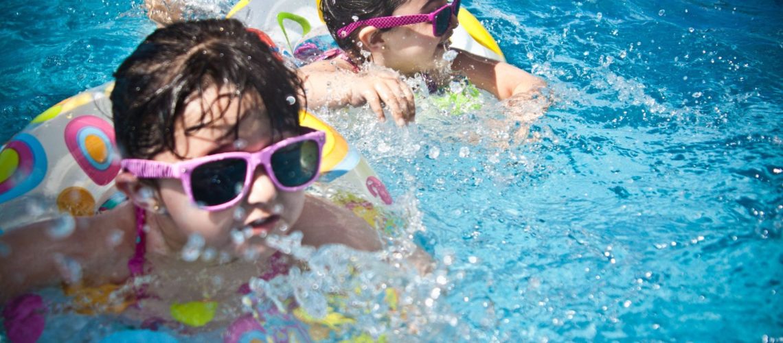 Kids Swimming Having Fun in Pool